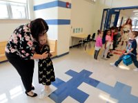 Abraham Lincoln elementary school  first grader, Quinn Beugart, embraces principal, Lina DeJesus, upon seeing her for the first time this school year, as students across New Bedford return to school.  [ PETER PEREIRA/THE STANDARD-TIMES/SCMG ]